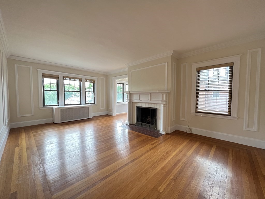 84 Winthrop Road Brookline, MA 02445 - Photo 21 of 42 a view of empty room with fireplace and wooden floor
