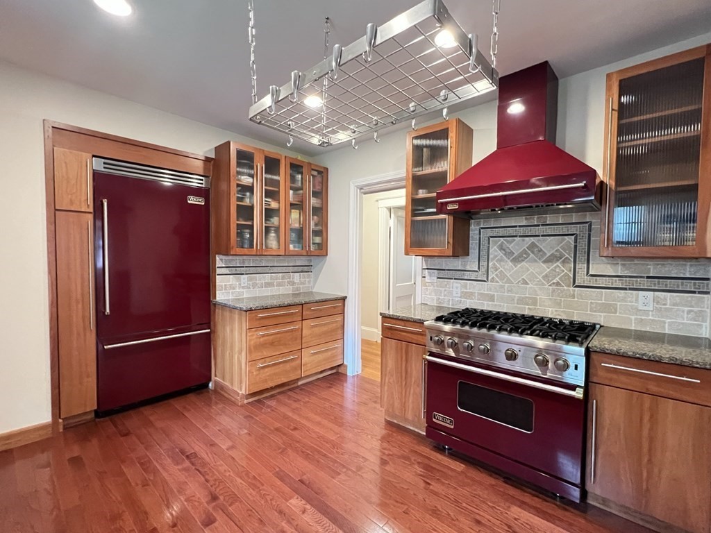 84 Winthrop Road Brookline, MA 02445 - Photo 24 of 42 a kitchen with stainless steel appliances granite countertop a stove and a refrigerator