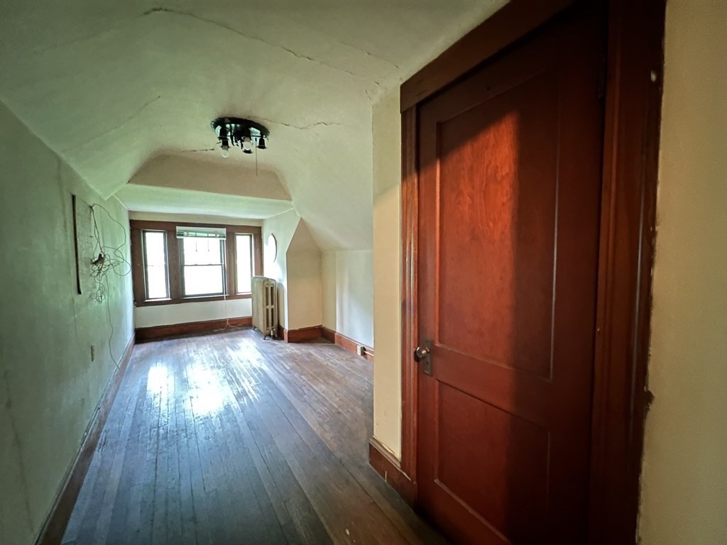 84 Winthrop Road Brookline, MA 02445 - Photo 36 of 42 a view of an empty room with wooden floor and a window