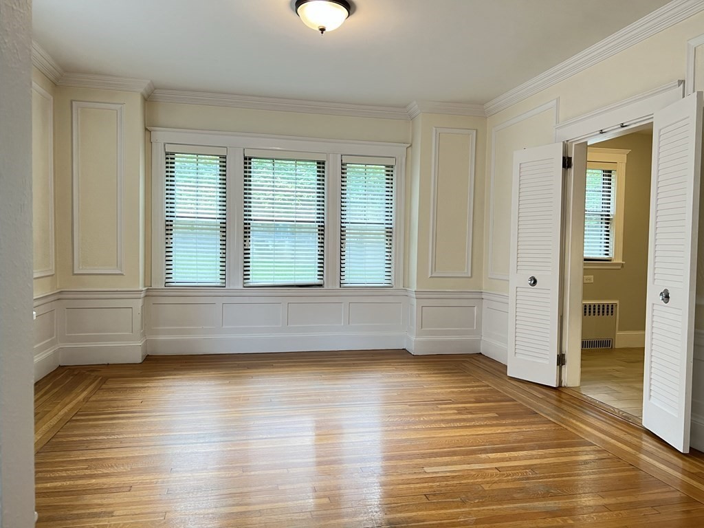 84 Winthrop Road Brookline, MA 02445 - Photo 6 of 42 a view of empty room with wooden floor and fan