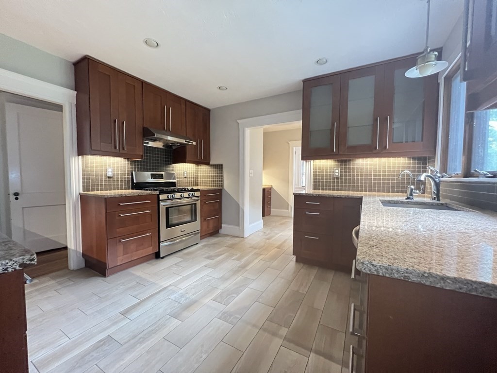 84 Winthrop Road Brookline, MA 02445 - Photo 7 of 42 a kitchen with stainless steel appliances granite countertop a sink stove and refrigerator