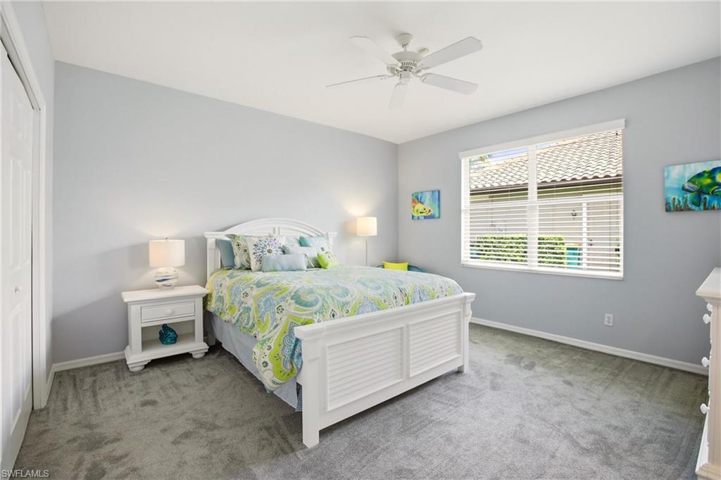 10815 Phoenix Way Naples, FL 34119 - Photo 21 of 40 a bedroom with a bed and a window
