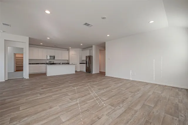 a view of a kitchen with a sink and a refrigerator