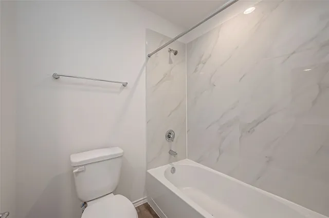 a bathroom with a toilet and a bathtub