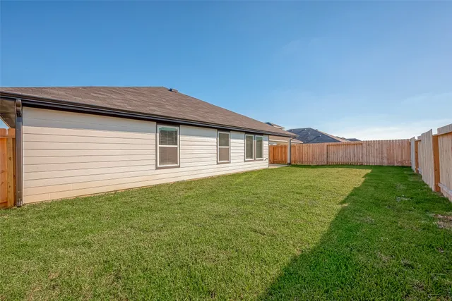 a backyard of a house with lots of green space