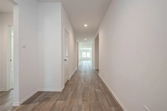 a view of hallway with wooden floor