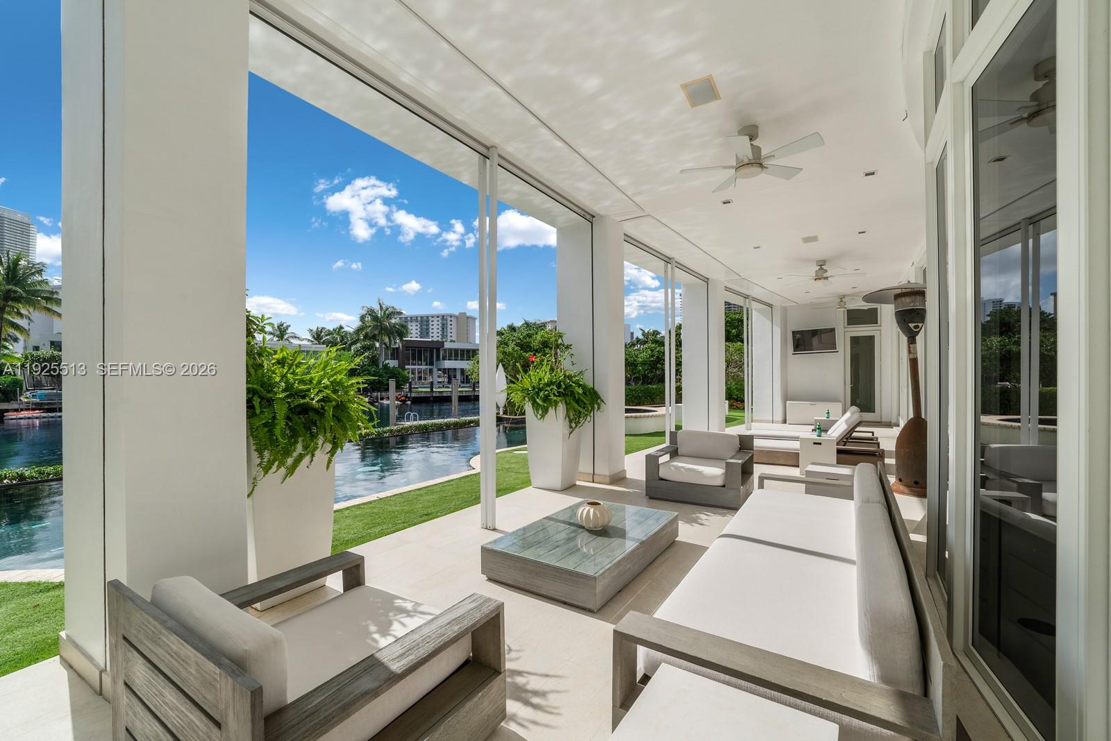 142 South Island Road Golden Beach, FL 33160 - Photo 12 of 55 a living room with furniture and a large window