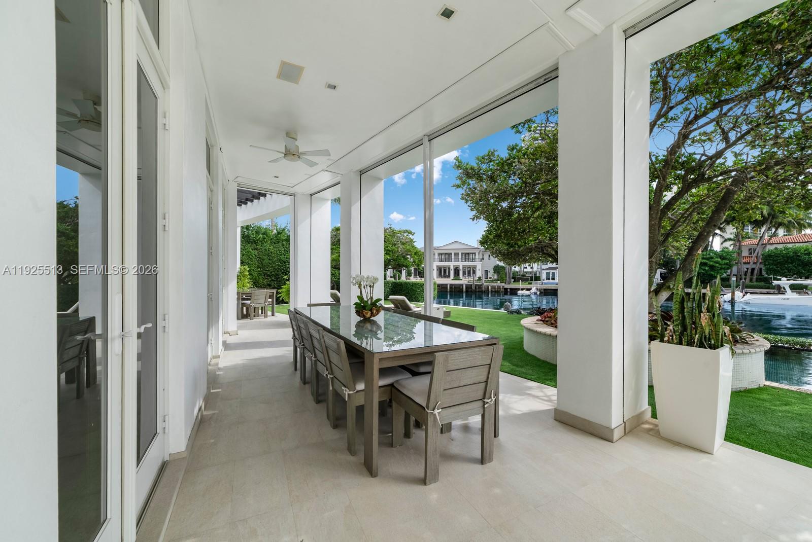 142 South Island Road Golden Beach, FL 33160 - Photo 13 of 55 a dining room with furniture and garden view