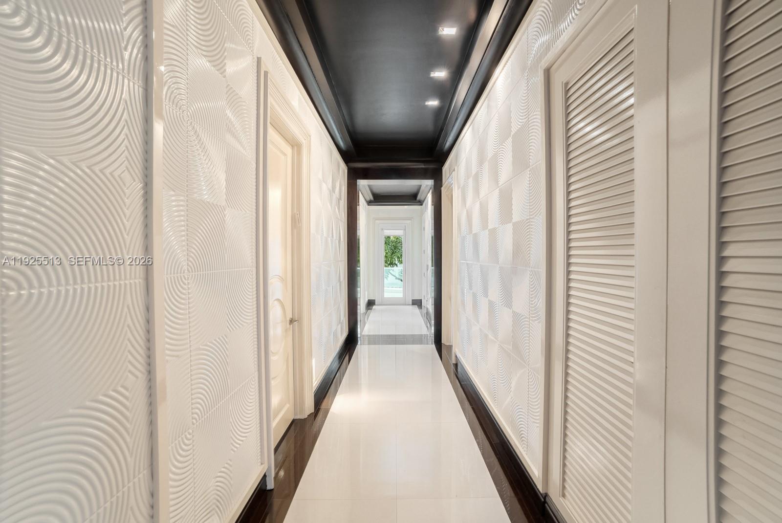 142 South Island Road Golden Beach, FL 33160 - Photo 21 of 55 a view of a hallway with wooden floor and staircase