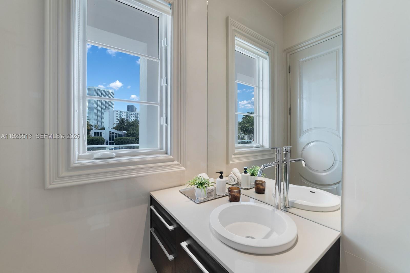 142 South Island Road Golden Beach, FL 33160 - Photo 23 of 55 a bathroom with a sink and a mirror