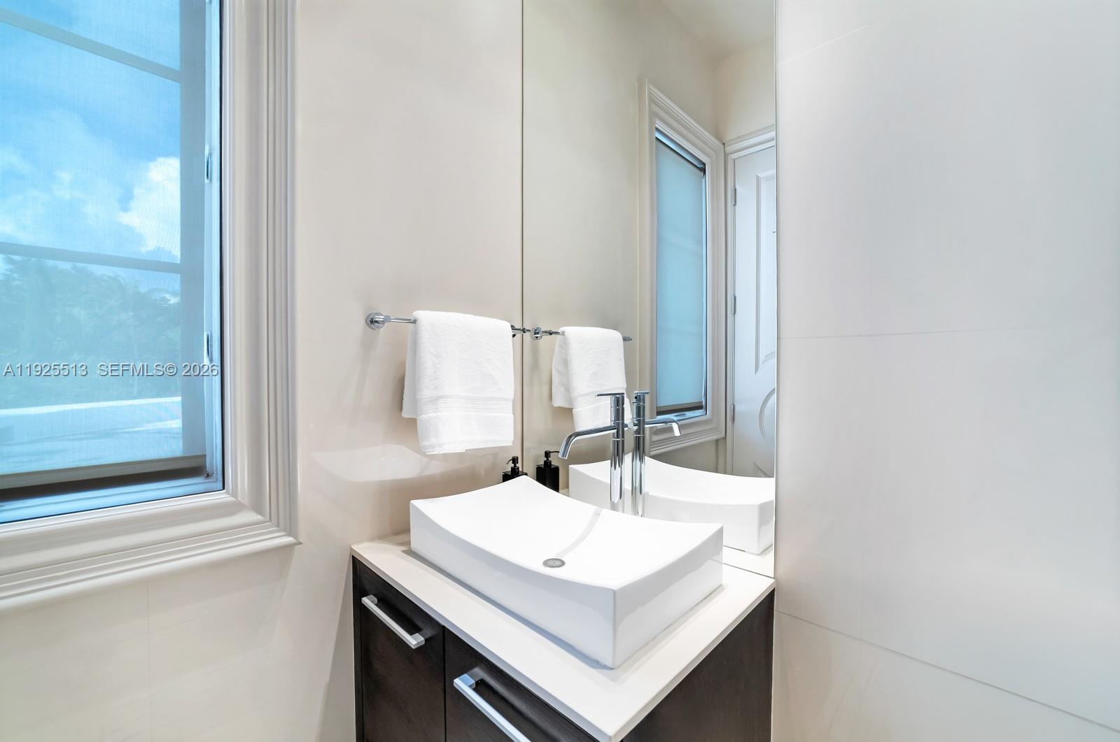 142 South Island Road Golden Beach, FL 33160 - Photo 25 of 55 a bathroom with a sink and a mirror