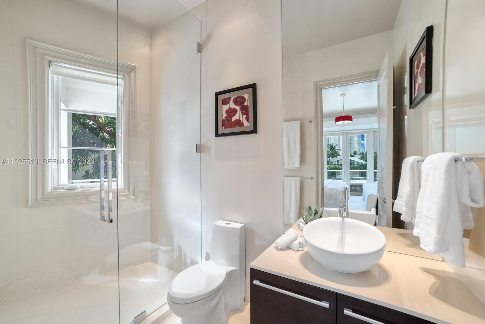 142 South Island Road Golden Beach, FL 33160 - Photo 27 of 55 a bathroom with a granite countertop sink and a mirror