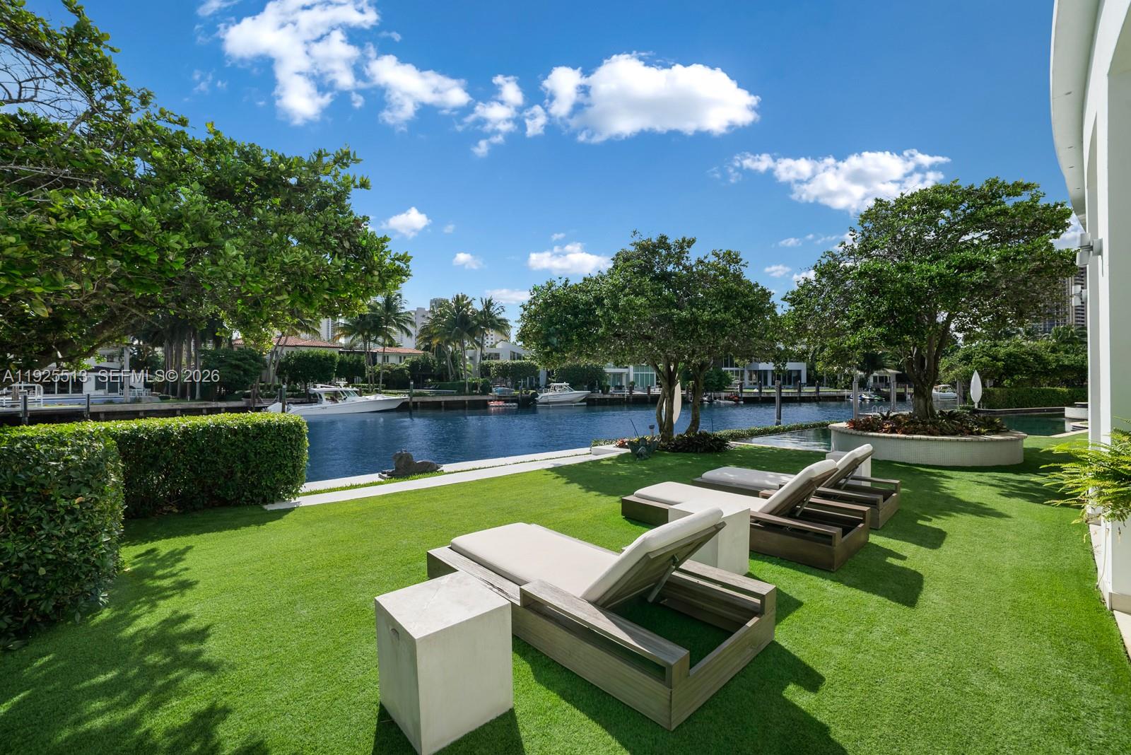 142 South Island Road Golden Beach, FL 33160 - Photo 46 of 55 a view of a house with swimming pool and sitting area