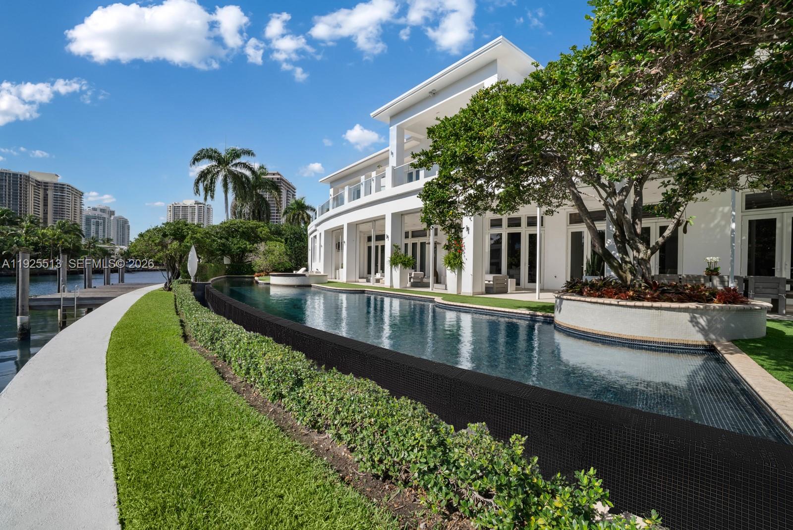 142 South Island Road Golden Beach, FL 33160 - Photo 47 of 55 a view of a house with swimming pool
