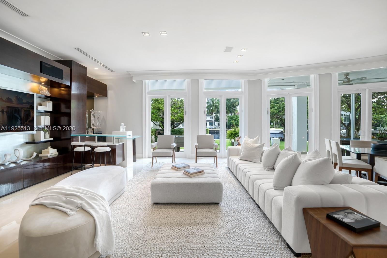 142 South Island Road Golden Beach, FL 33160 - Photo 7 of 55 a living room with furniture and a large window
