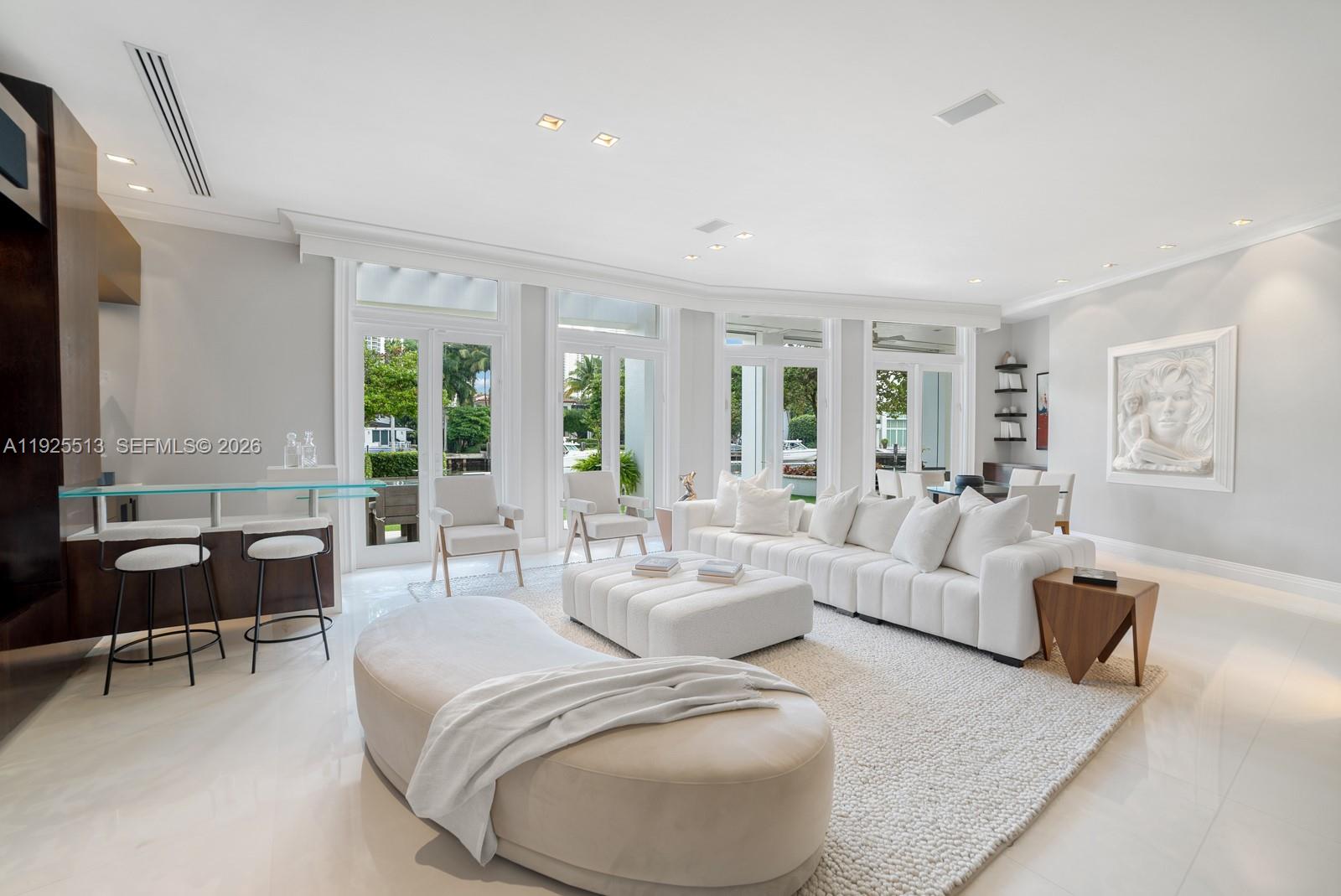 142 South Island Road Golden Beach, FL 33160 - Photo 8 of 55 a living room with furniture and a large window