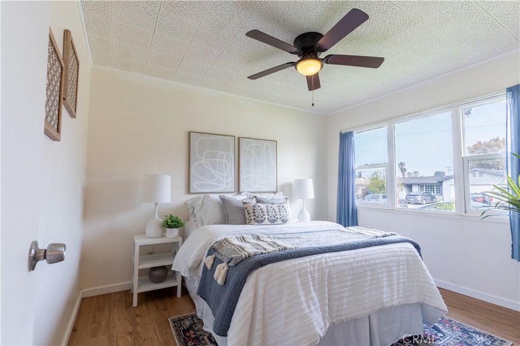 660 Armstead Street Glendora, CA 91740 - Photo 5 of 7 a bedroom with a bed a window and a chandelier