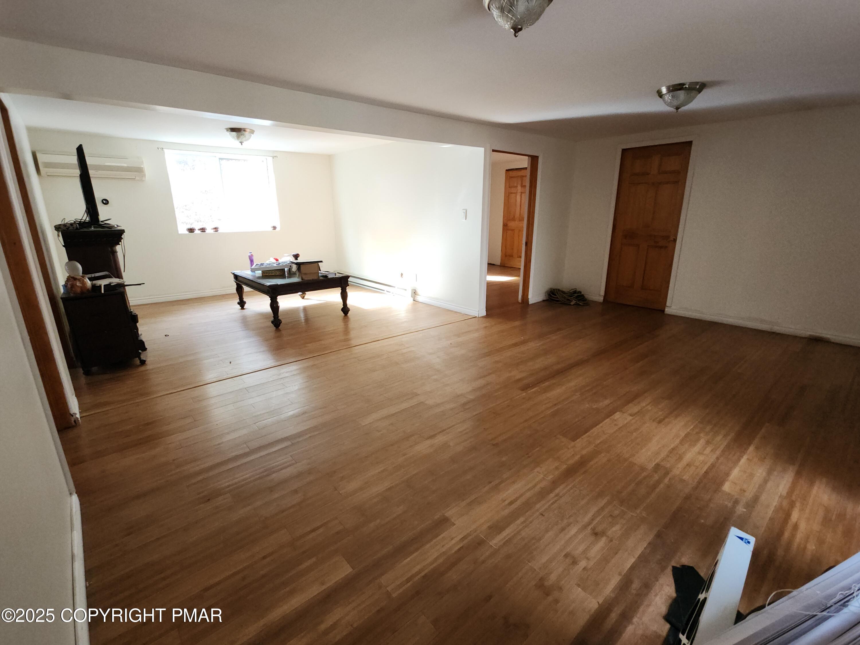280 Coolbaugh Road East Stroudsburg, PA 18302 - Photo 16 of 40 a view of an empty room with wooden floor and a window