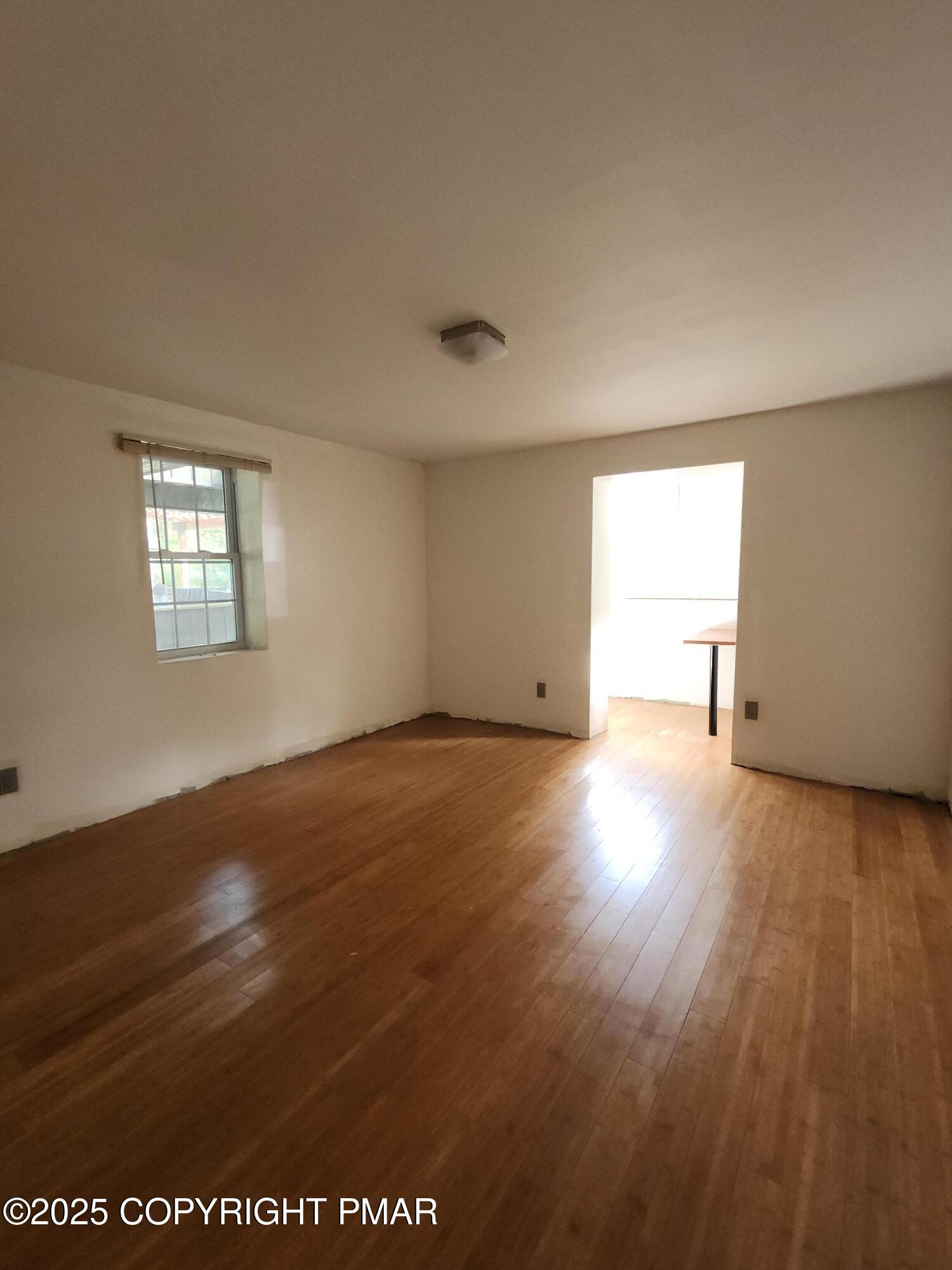 280 Coolbaugh Road East Stroudsburg, PA 18302 - Photo 20 of 40 an empty room with wooden floor and windows