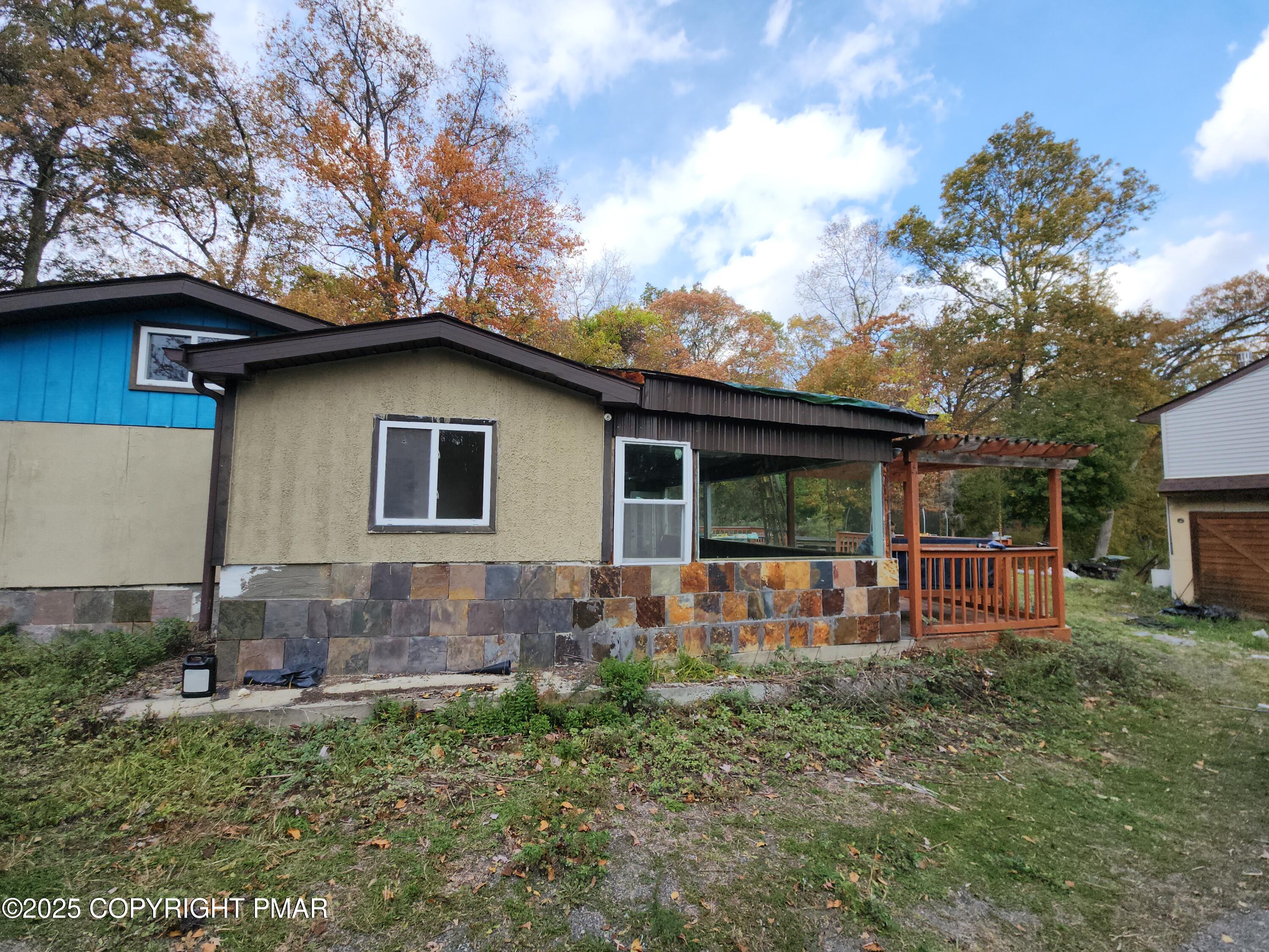 280 Coolbaugh Road East Stroudsburg, PA 18302 - Photo 2 of 40 a backyard of a house with table and chairs