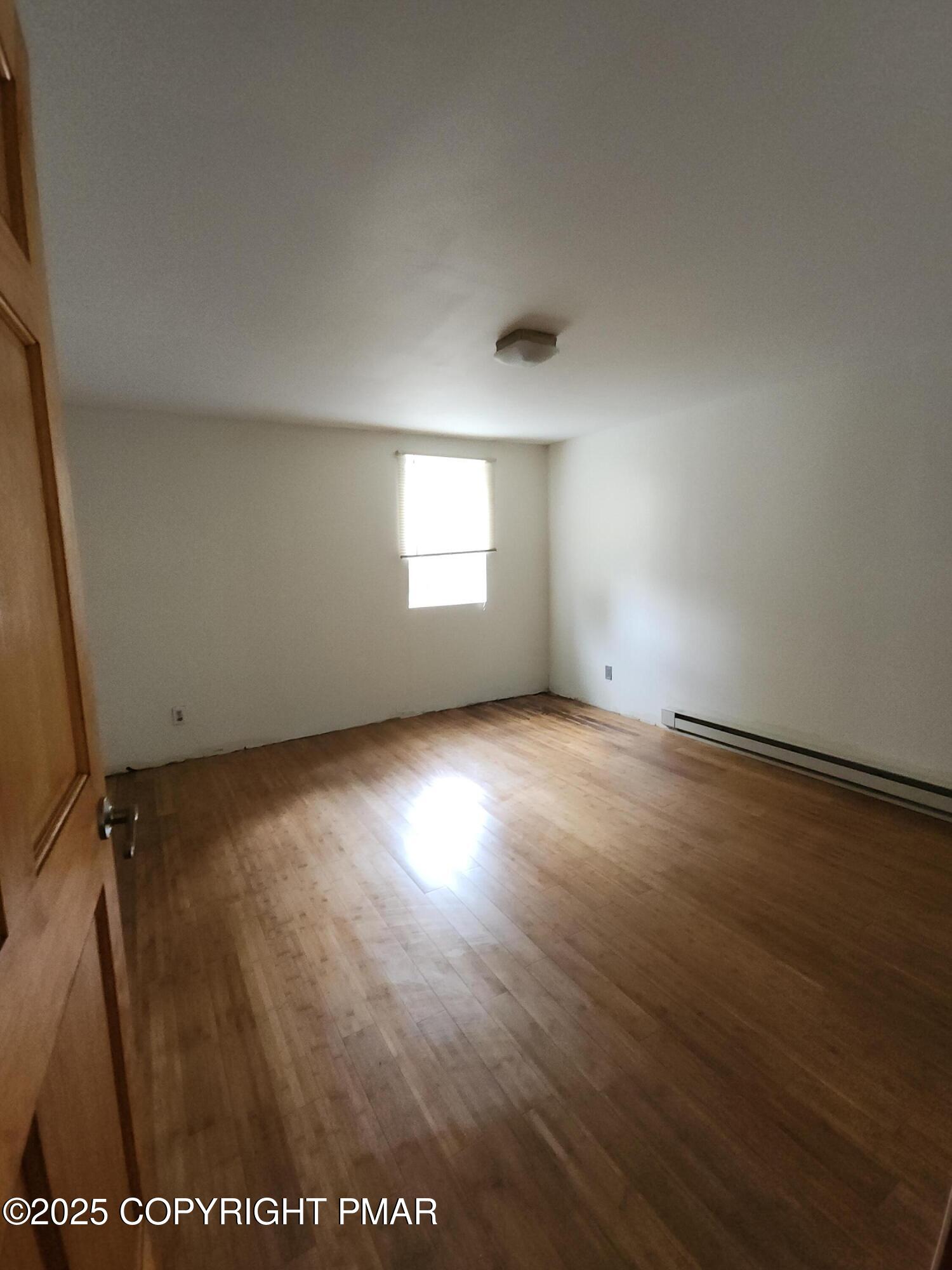 280 Coolbaugh Road East Stroudsburg, PA 18302 - Photo 23 of 40 an empty room with wooden floor and windows
