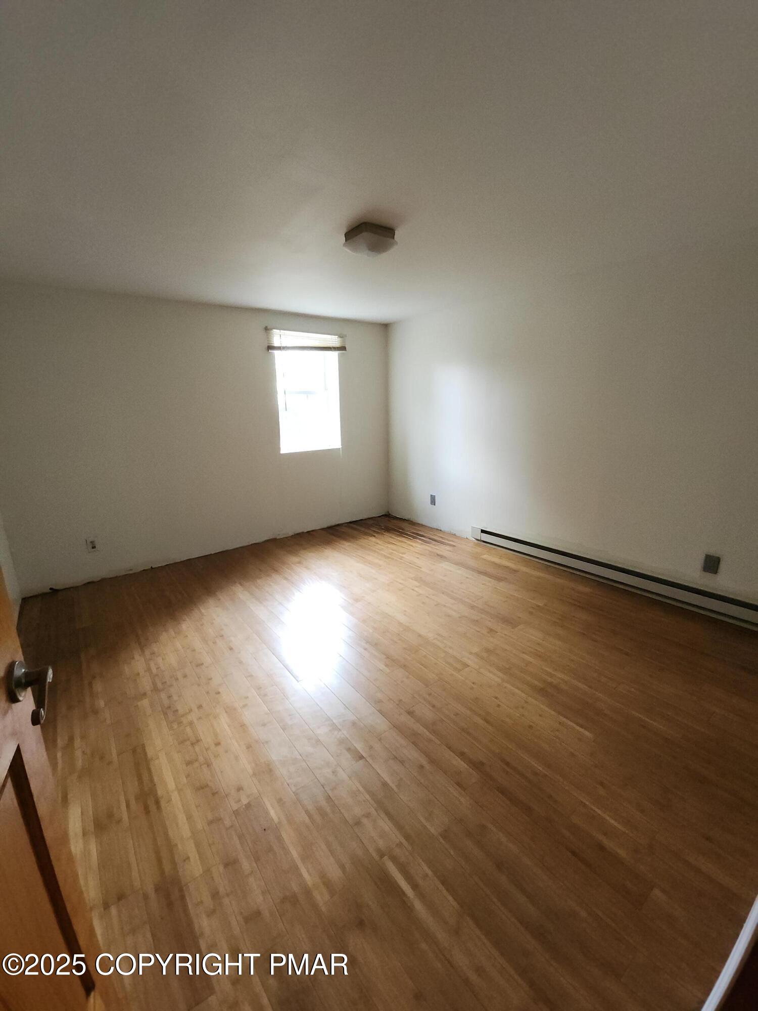 280 Coolbaugh Road East Stroudsburg, PA 18302 - Photo 24 of 40 an empty room with wooden floor and windows