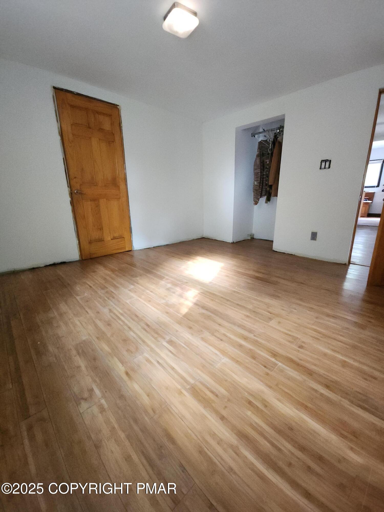 280 Coolbaugh Road East Stroudsburg, PA 18302 - Photo 26 of 40 an empty room with wooden floor and windows