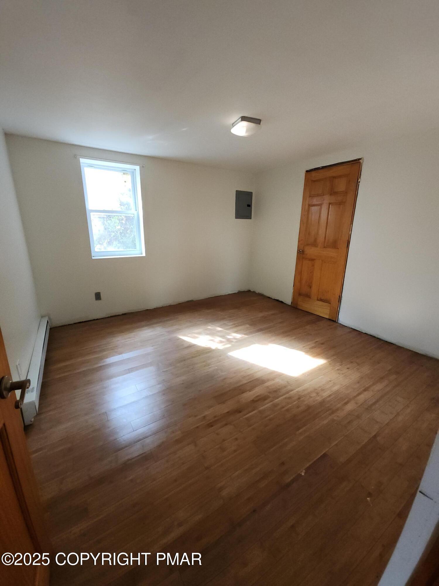 280 Coolbaugh Road East Stroudsburg, PA 18302 - Photo 27 of 40 an empty room with wooden floor and windows