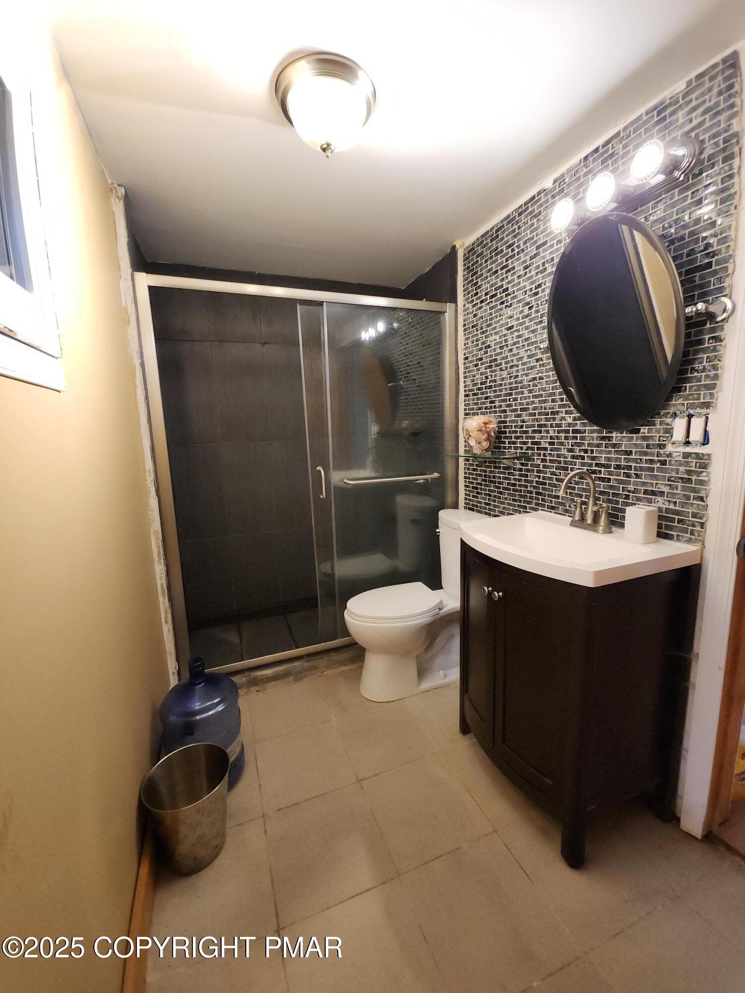 280 Coolbaugh Road East Stroudsburg, PA 18302 - Photo 28 of 40 a bathroom with a sink vanity mirror and toilet