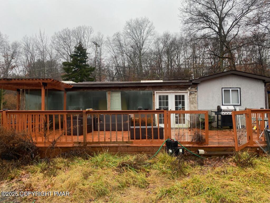 280 Coolbaugh Road East Stroudsburg, PA 18302 - Photo 3 of 40 a view of a house with a wooden deck
