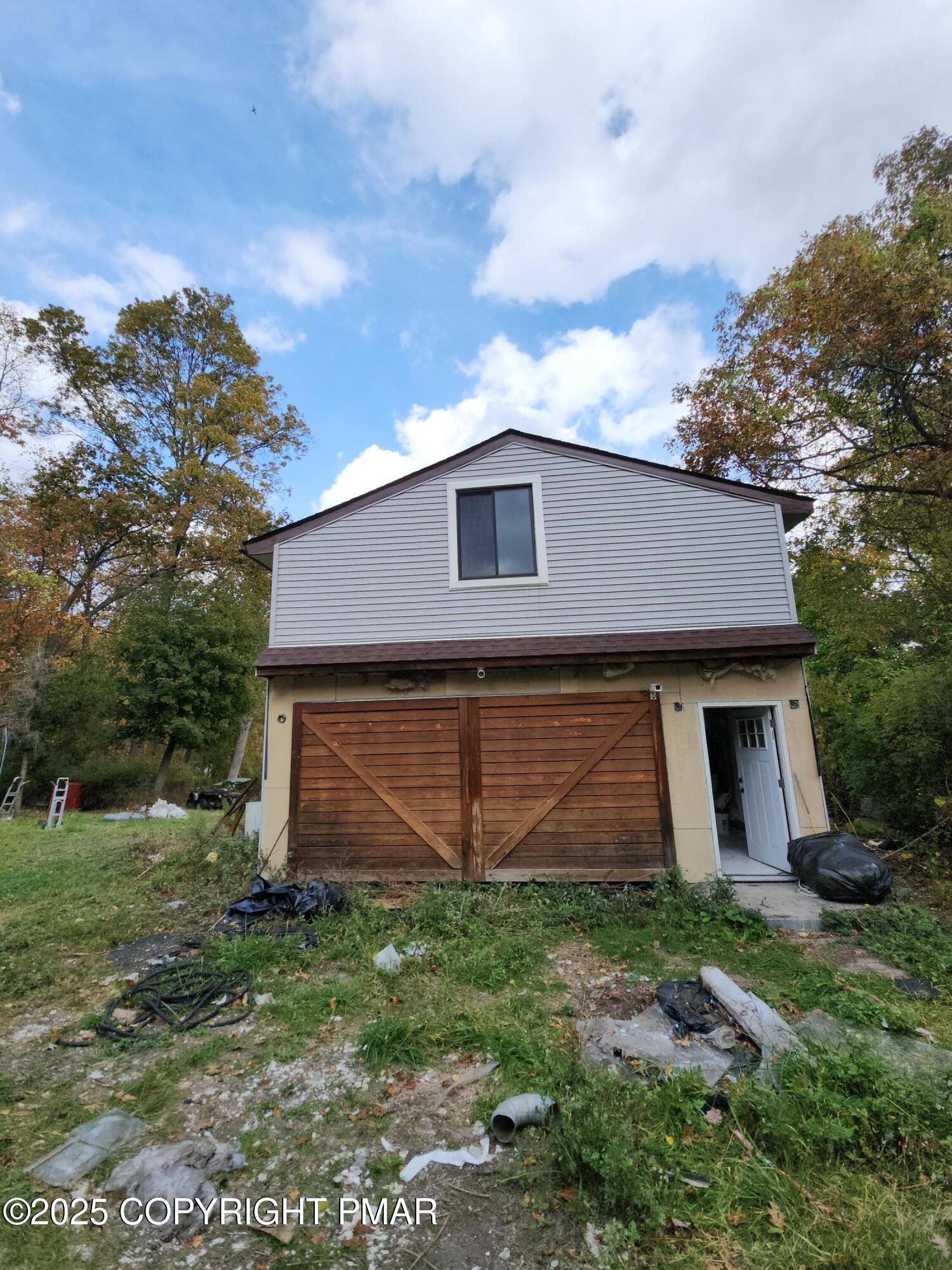 280 Coolbaugh Road East Stroudsburg, PA 18302 - Photo 8 of 40 a front view of a house with a garden and plants