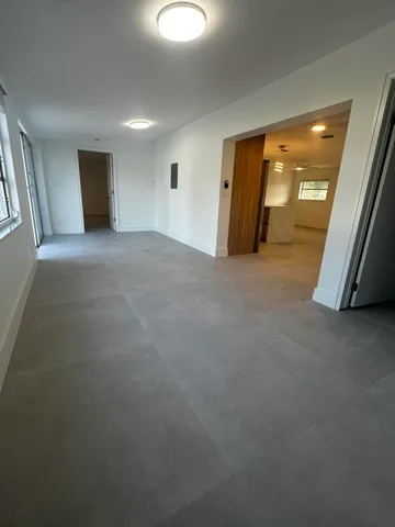 a view of a livingroom with an empty space and a window