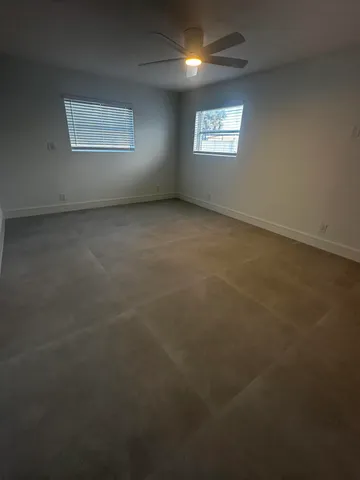 an empty room with a empty space and windows