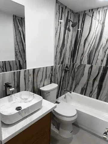 a bathroom with a sink a toilet and a bathtub