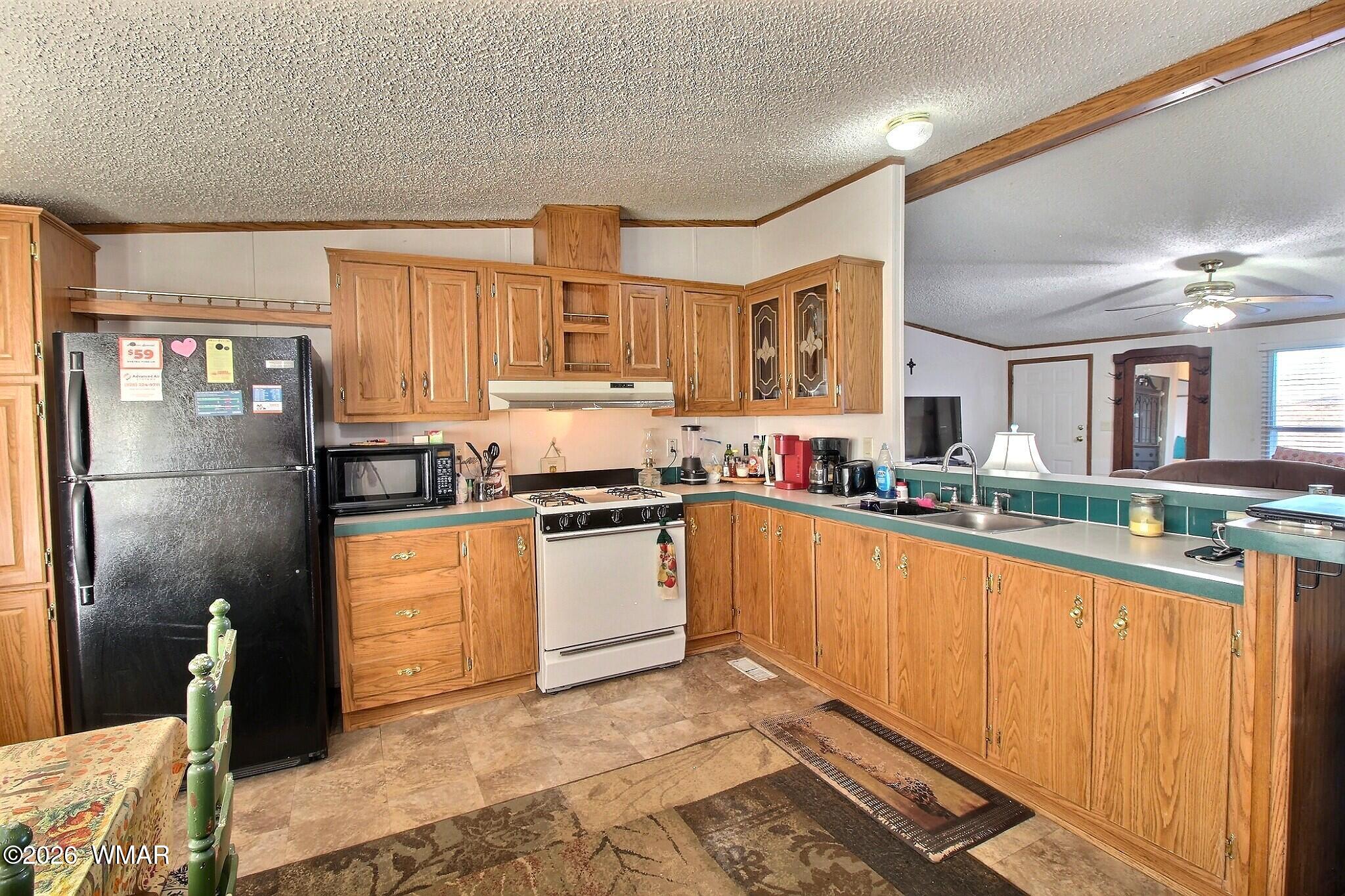 4710 Hay Hollow Road Snowflake, AZ 85937 - Photo 10 of 20 a kitchen with stainless steel appliances granite countertop a refrigerator sink and cabinets