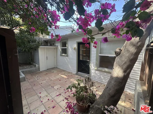 a front view of a house with a tree