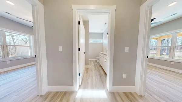 a view of a hallway with wooden floor and staircase