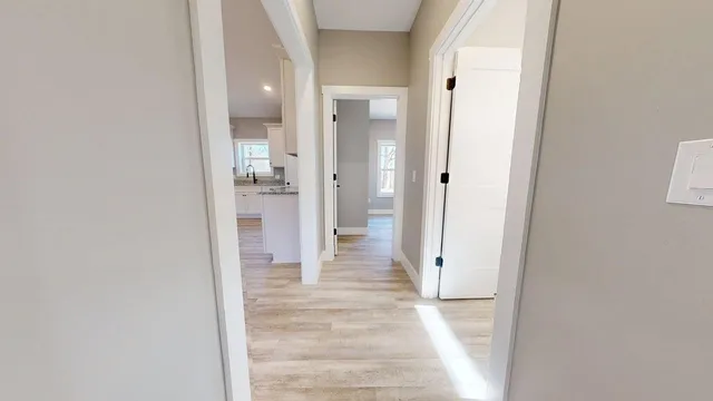 an empty room with windows and a ceiling fan
