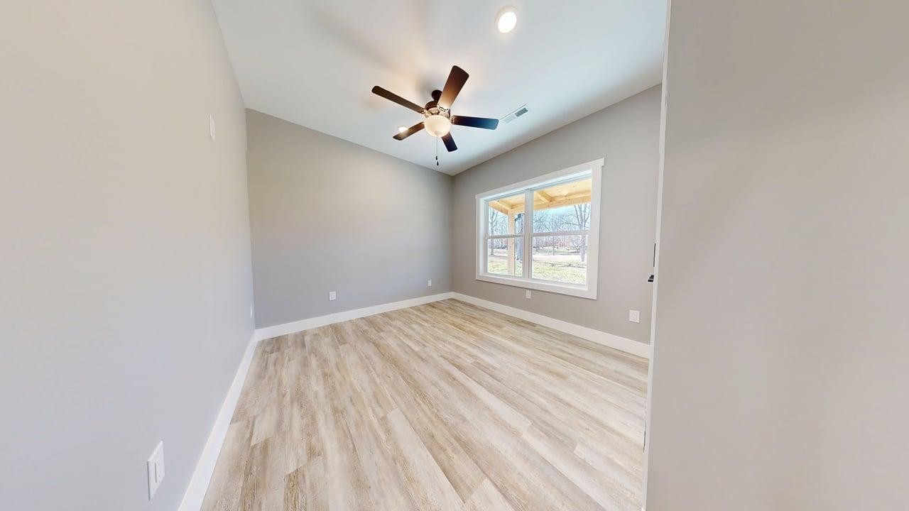 1490 Highway 100 Centerville, TN 37033 - Photo 14 of 28 an empty room with windows and ceiling fan