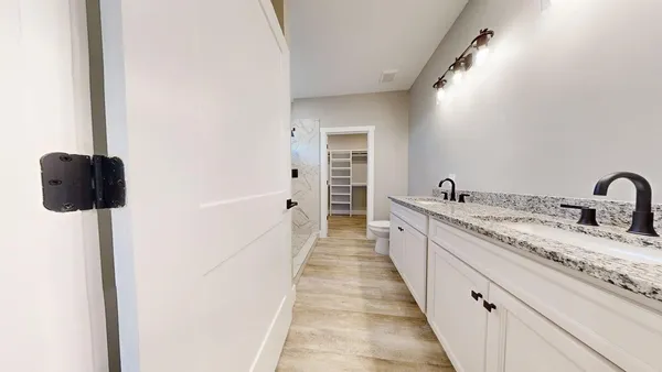 a large white kitchen with sink and mirror