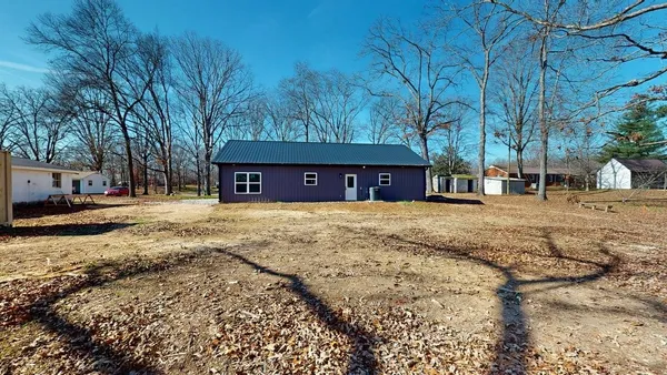 a view of a house with a yard covered with snow
