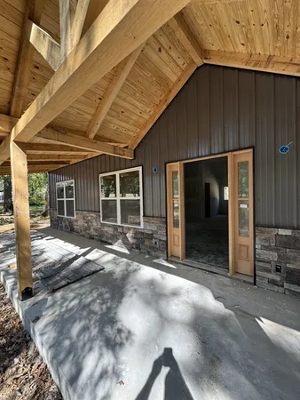 a view of a house with backyard porch and sitting area
