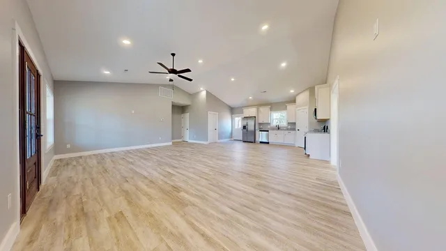 a view of a kitchen with a sink and a refrigerator