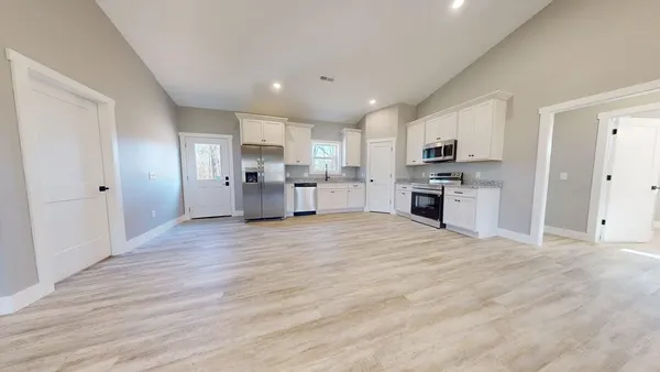 a view of a kitchen with a sink and a refrigerator