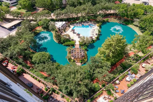 an aerial view of a residential houses with outdoor space and swimming pool