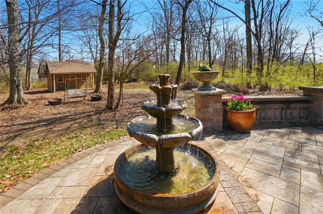 472 Timber Walk Court Springboro, OH 45066 - Photo 71 of 86 This private outdoor space features a water fountain and a charming shed, offering a tranquil retreat.