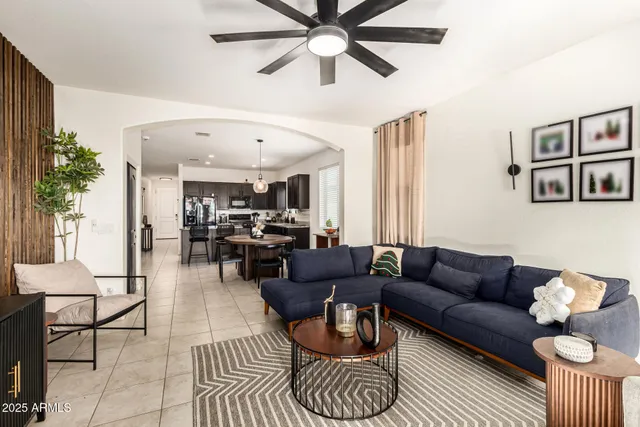 a living room with furniture a rug and a chandelier