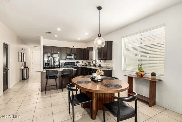 a kitchen with a dining table chairs and view kitchen