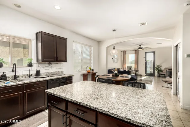 a kitchen with sink counter top space and living room