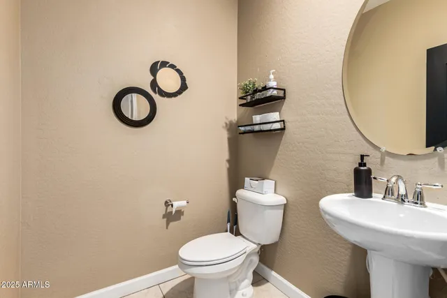 a bathroom with a sink mirror and toilet